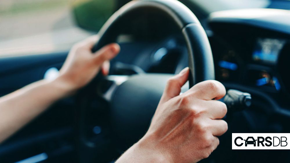 male-hands-holding-steering-wheel-1012236786_6a84ec.jpg