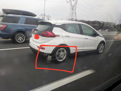 Genius Chevrolet Bolt driver attaches belt to rear wheel and generator to charge its battery while driving